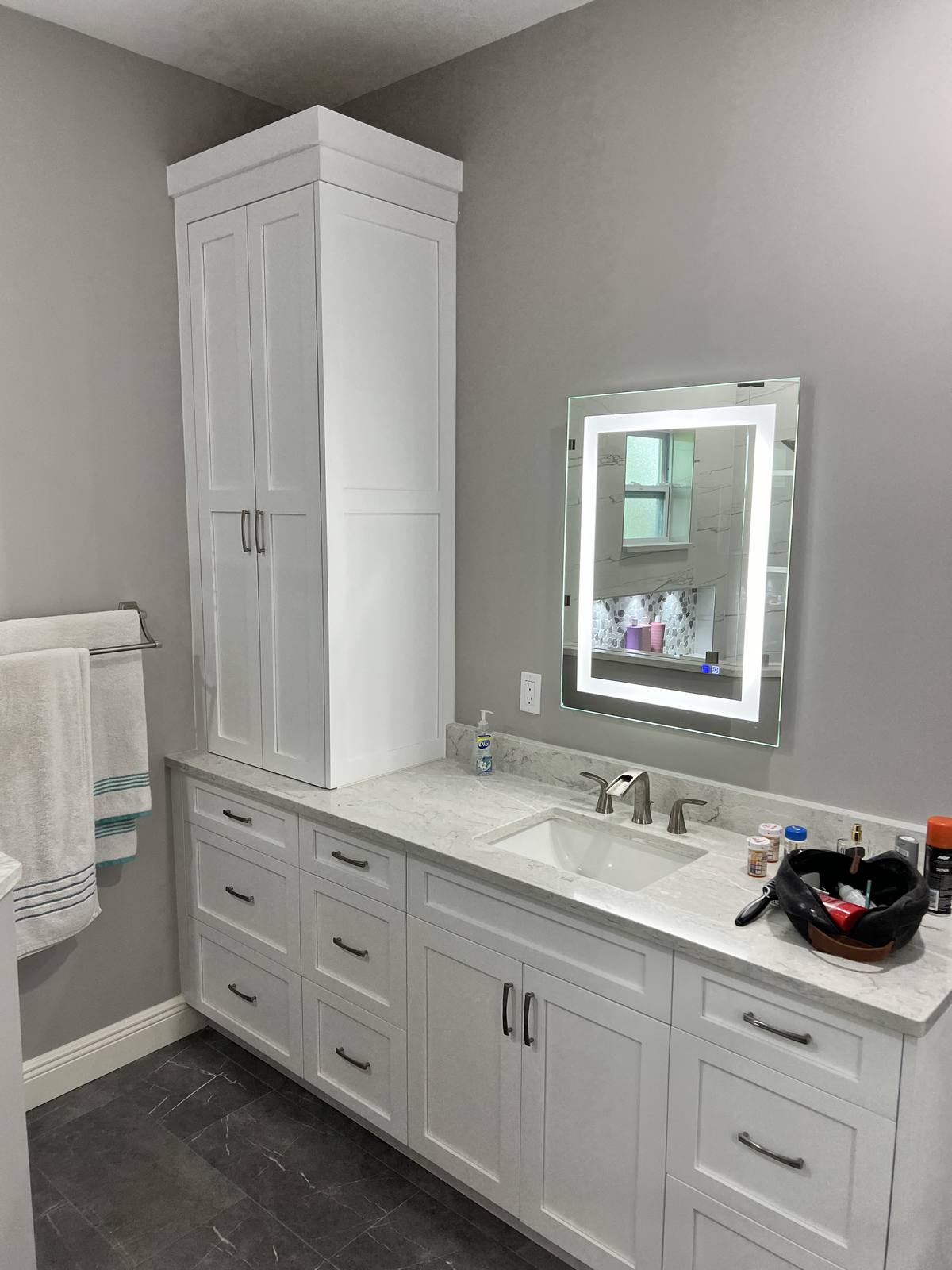 Double vanity with tall lit mirrors