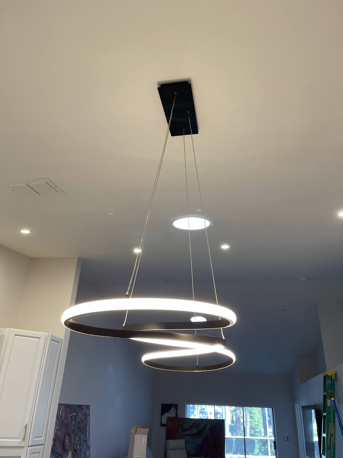 Modern ring pendant lighting over an island