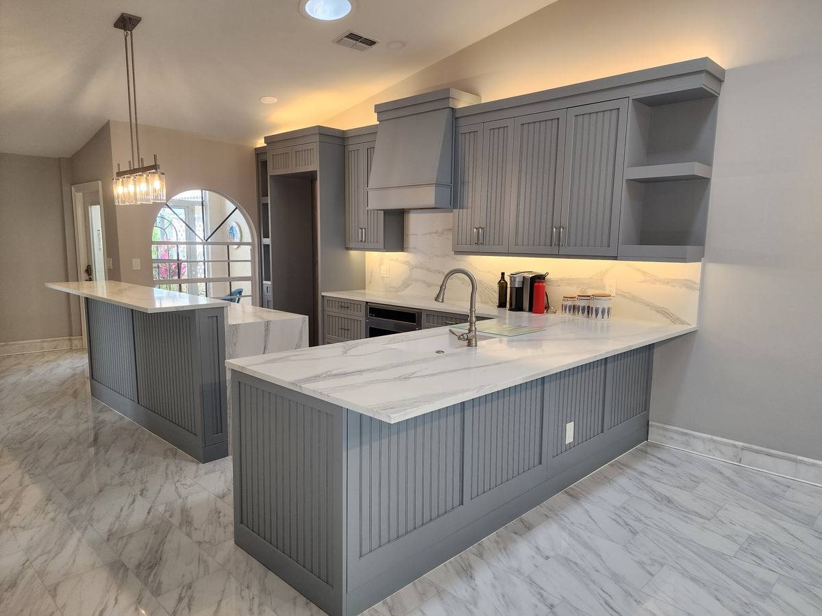 Finished Naples kitchen remodel with island seating and pendant lighting
